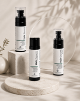 SkinCeutics anti hair fall serum, spray and shampoo bottles on a stone display